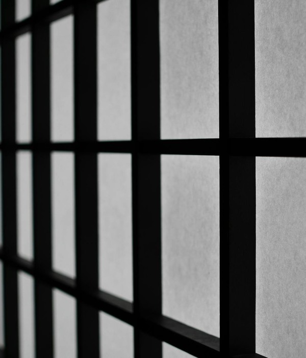 Abstract black and white geometric window pattern creating a moody atmosphere.